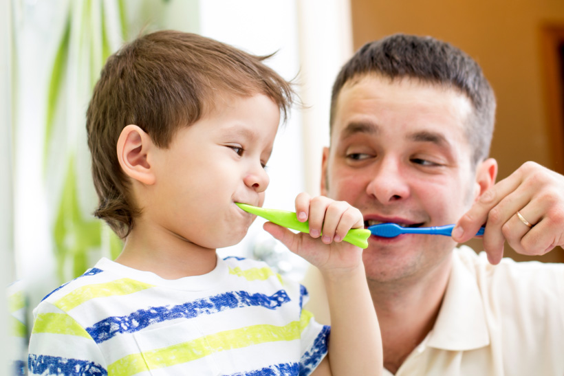 father-and-son-brushing-teeth